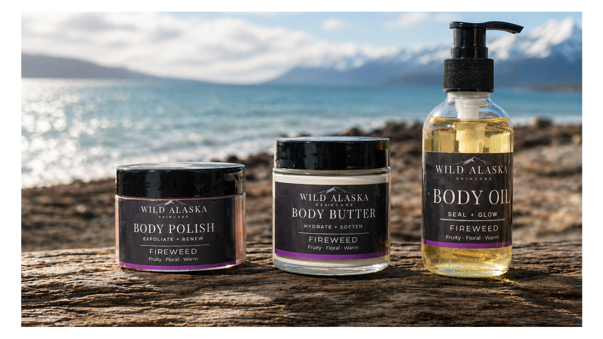 Wild Alaska Skincare products on a wooden surface with a scenic background