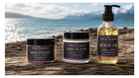 Wild Alaska Skincare products on a wooden surface with a scenic background