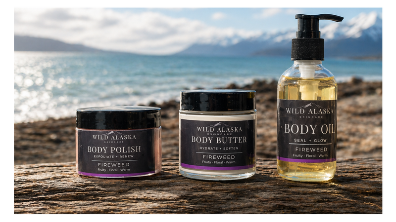 Wild Alaska Skincare products on a wooden surface with a scenic background