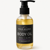 Bottle of Wild Alaska Skincare body oil with pump on a white background
