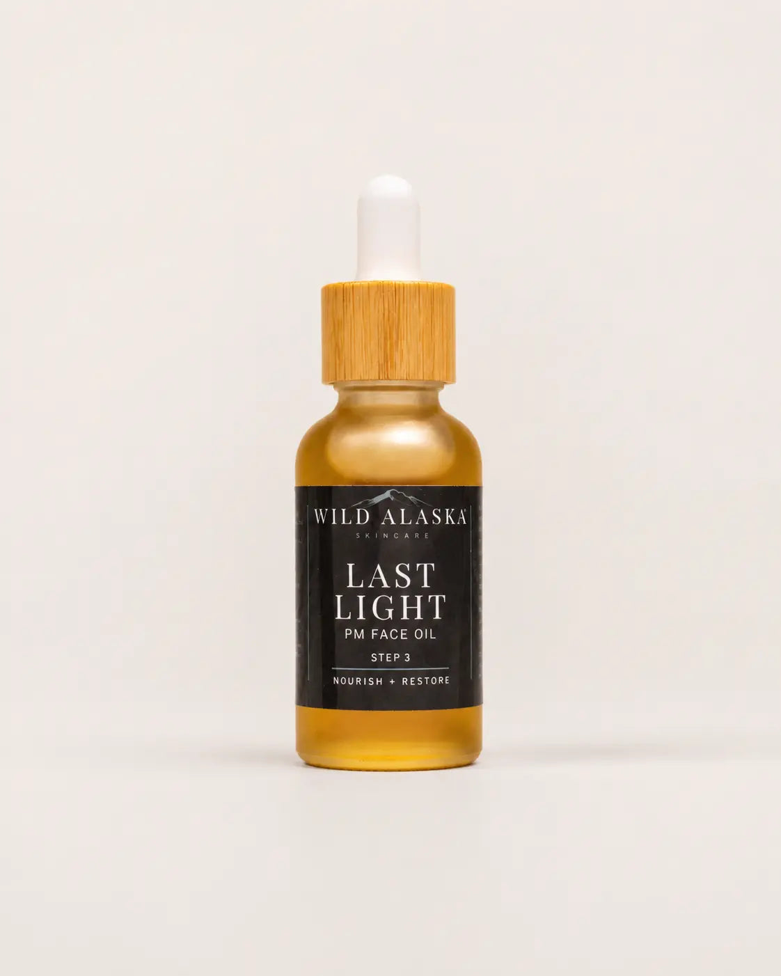 Bottle of Wild Alaska Skincare Last Light PM Face Oil on a white background
