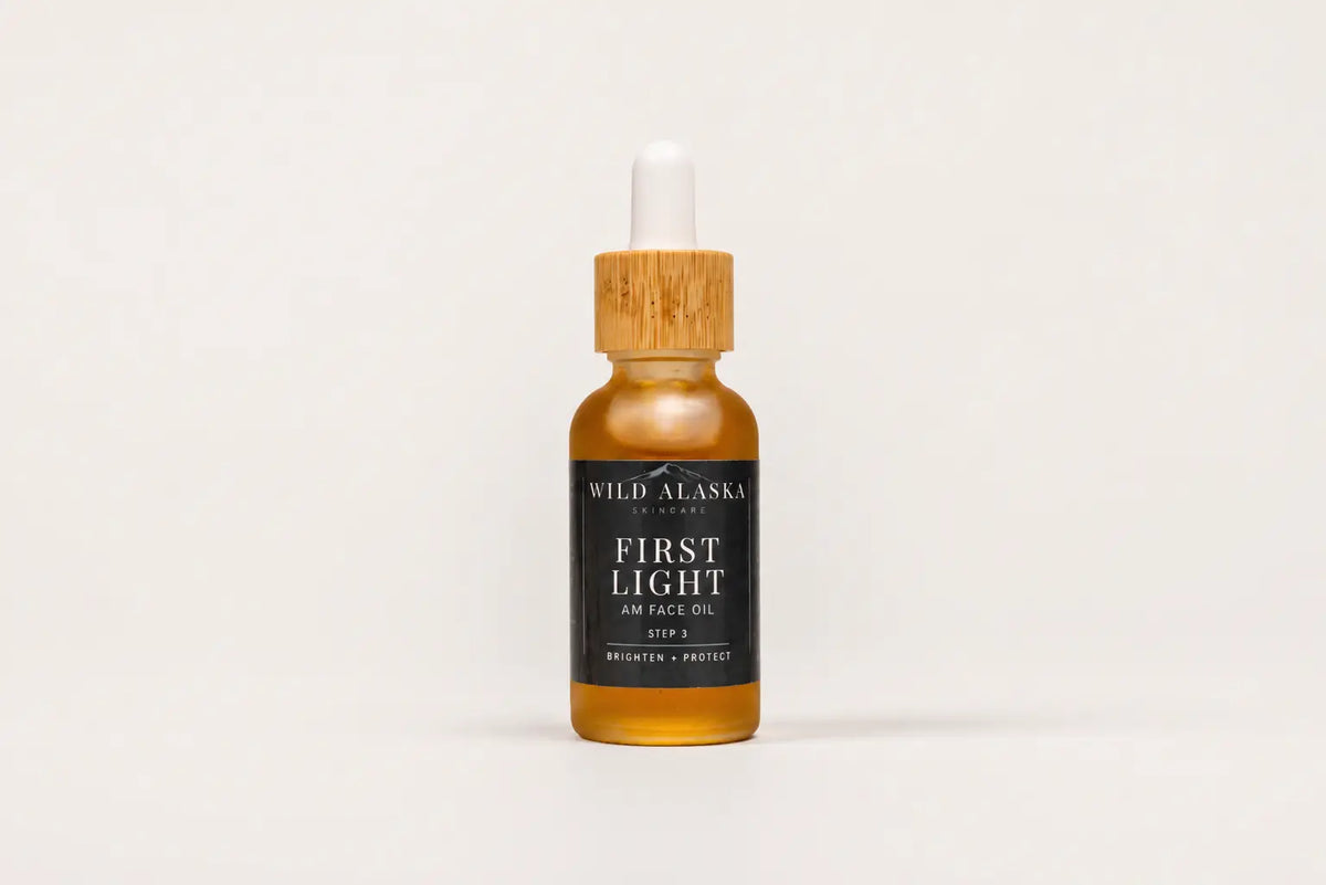 Bottle of Wild Alaska Naturals First Light skin and face oil on a white background