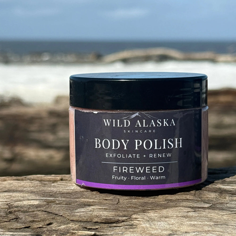 Body polish jar labeled 'Wild Alaska Skincare' on a wooden surface